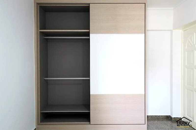 Built-in Wardrobe in an HDB Bedroom: Sliding or Swing Doors, and What to Settle Before the Carpenter Draws It